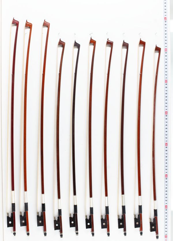 Eighteen child-sized violin bows, various lengths