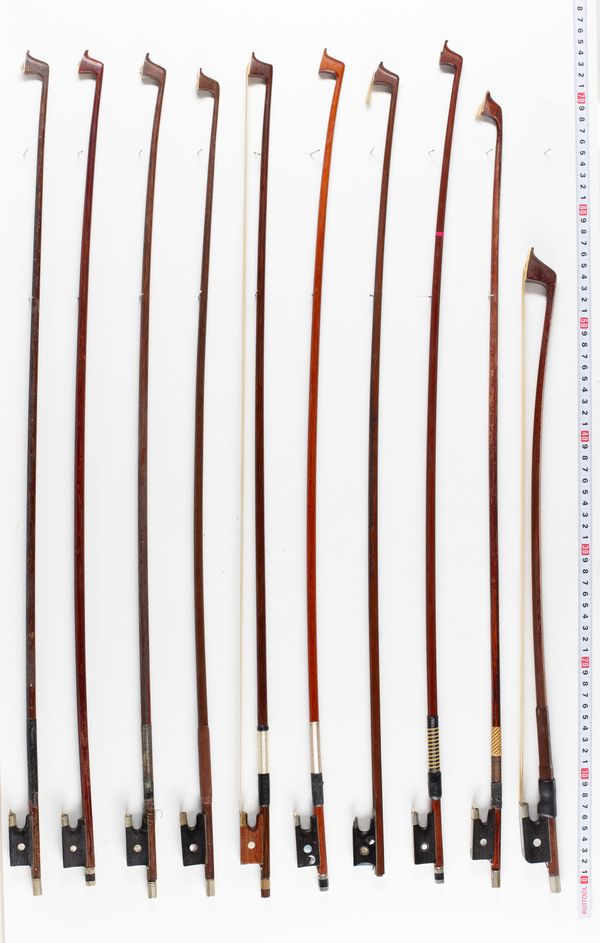 Sixteen violin bows and four cello bows, various lengths