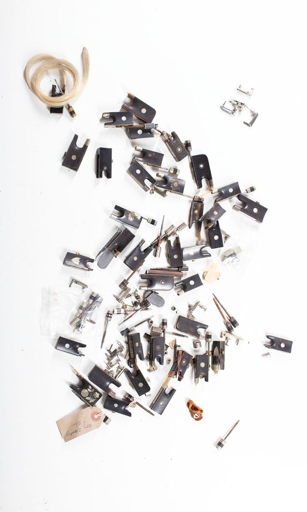 A bundle of thirty-seven bow frogs and various bow parts