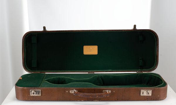 A violin case, branded Paxman