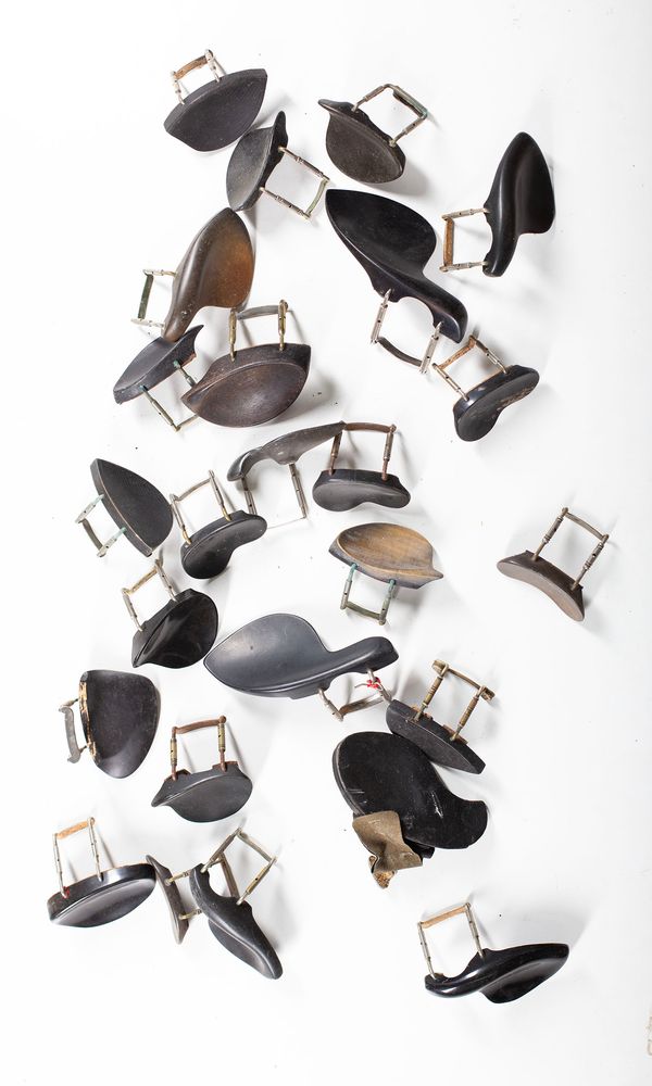 A bundle of twenty-five chin rests, varying sizes