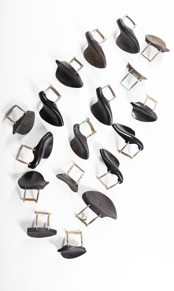 A bundle of eighteen chin rests, varying sizes