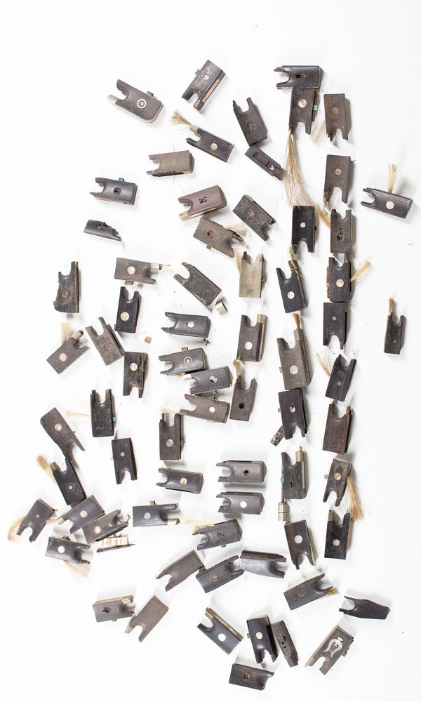 A bundle of sixty-five violin / viola frogs (without adjusters), varying sizes