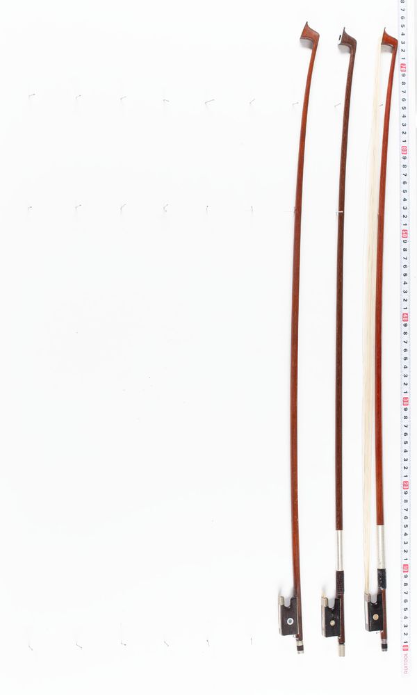 A bundle of three violin bows, varying sizes
