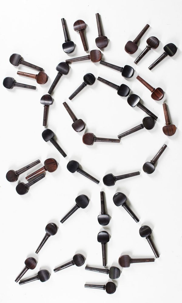 A bundle of fifty-four cello peg, varying sizes