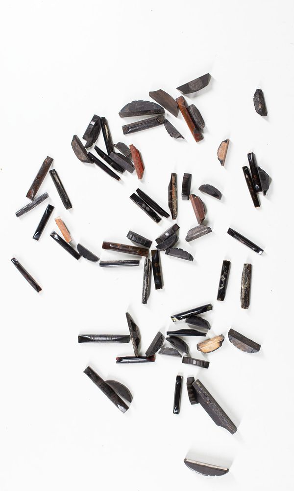 A bundle of sixty-four mixed cello and violin nuts, varying sizes