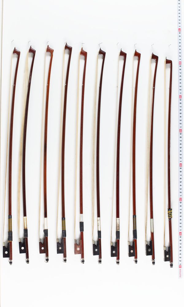 Seventeen half-sized violin bows, varying lengths