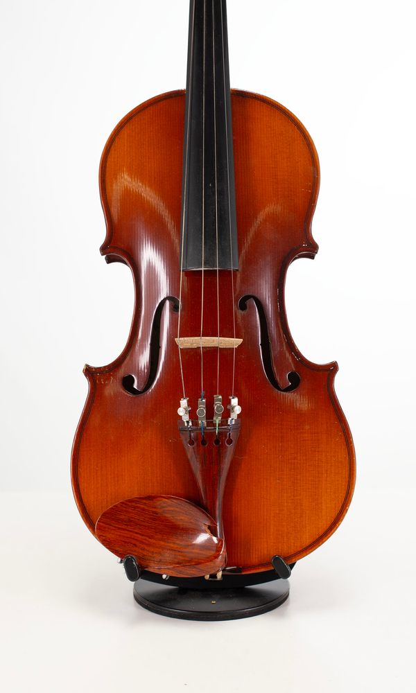 A three-quarter sized violin and a full-sized violin