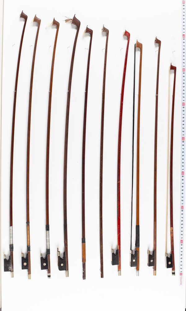 A bundle of fourteen bows and five bow sticks, varying sizes