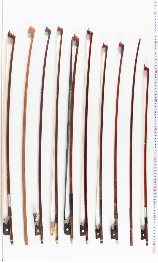 A bundle of twenty-one bows and four bow sticks, varying lengths