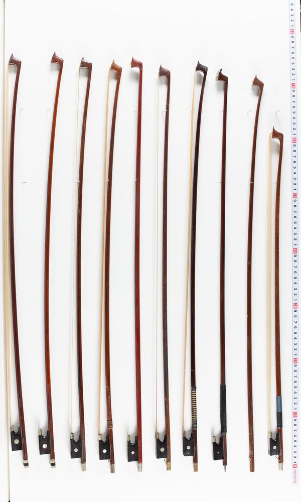 A bundle of sixteen bows and four bow sticks, varying lengths