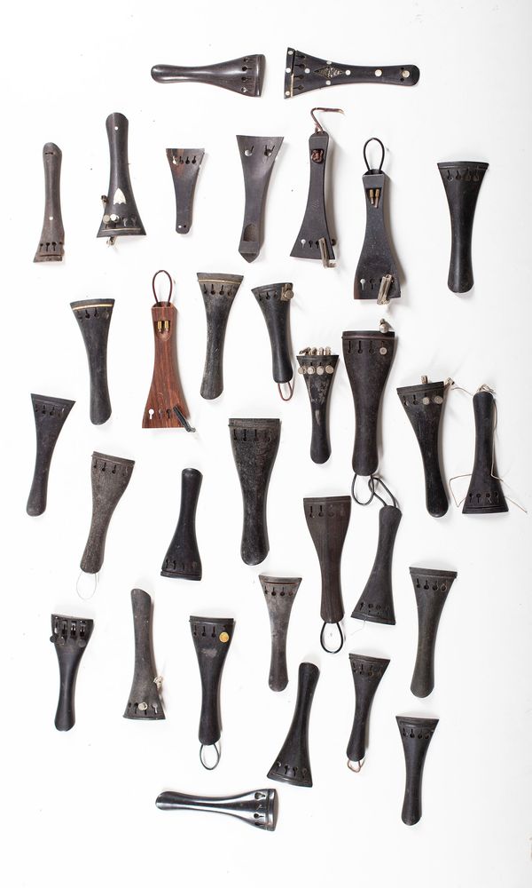A bundle of sixty-one violin tailpieces, varying sizes