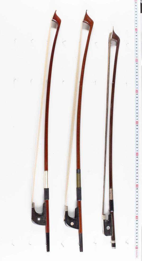 A bundle of three double bass bows, varying sizes