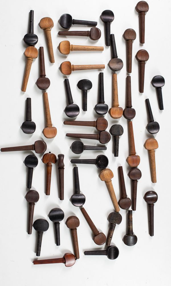 A large quantity of cello pegs, various sizes