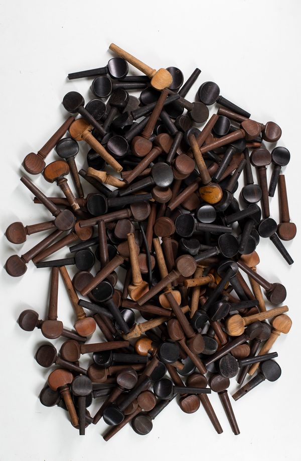 A large quantity of cello pegs, various sizes