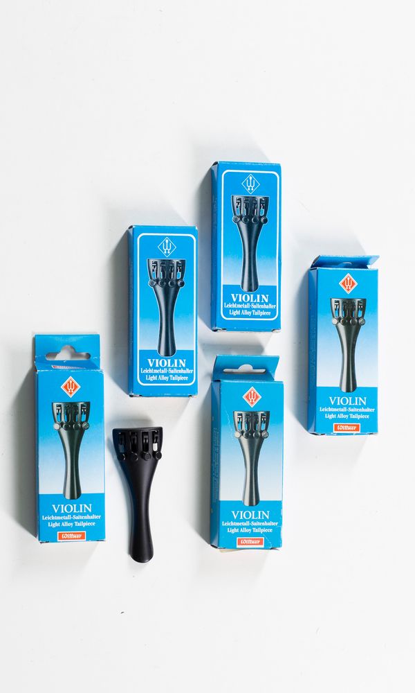 Five violin tailpieces, various sizes