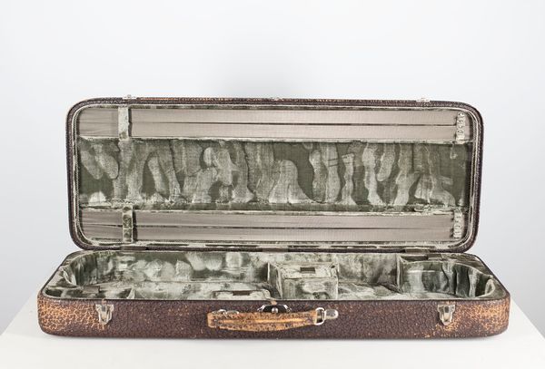 A double violin case, branded Vidoudez