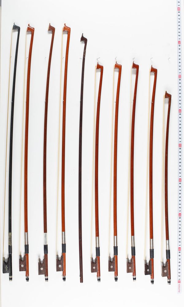 Eight violin bows, one stick and thirteen child-sized violin bows