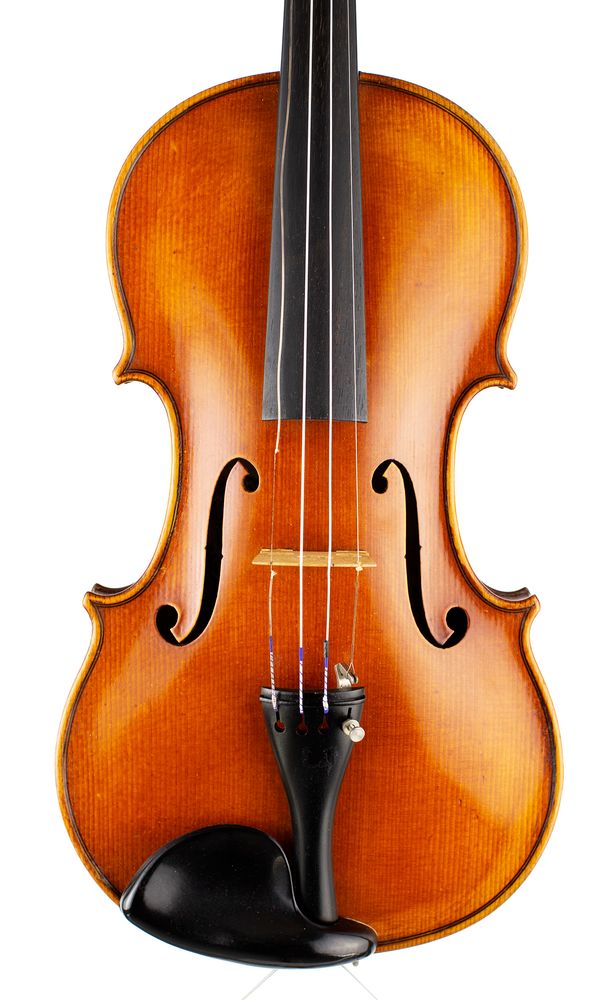 A violin, labelled Cesare Candi