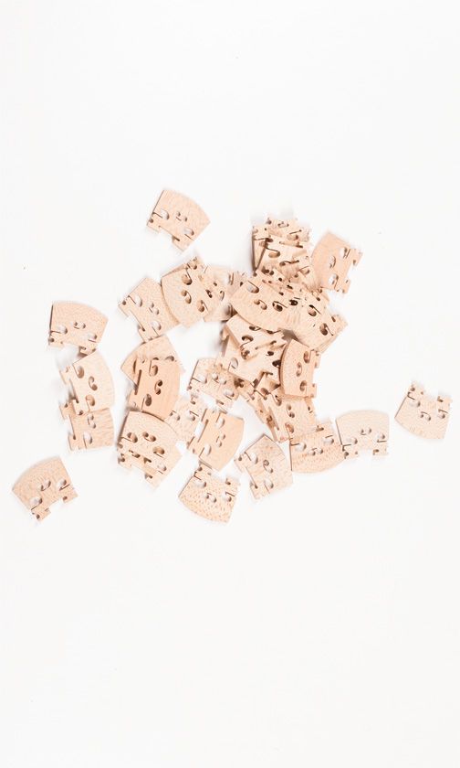 Forty quarter size violin bridges