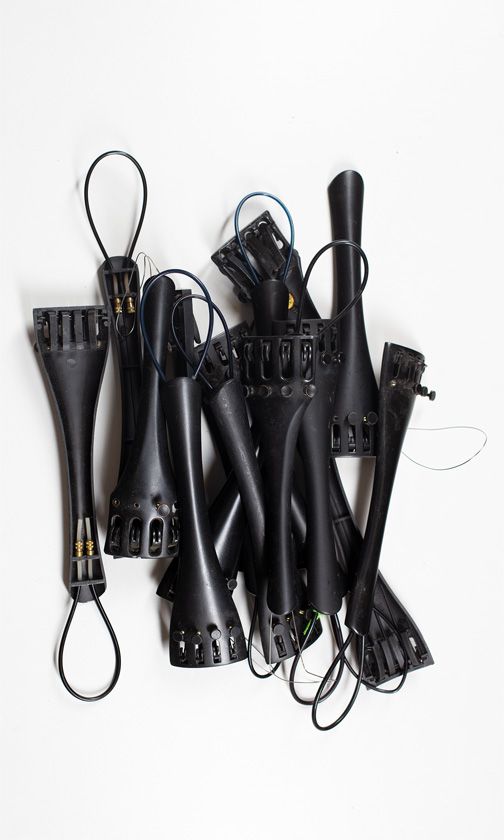 Sixteen cello tailpieces of various sizes
