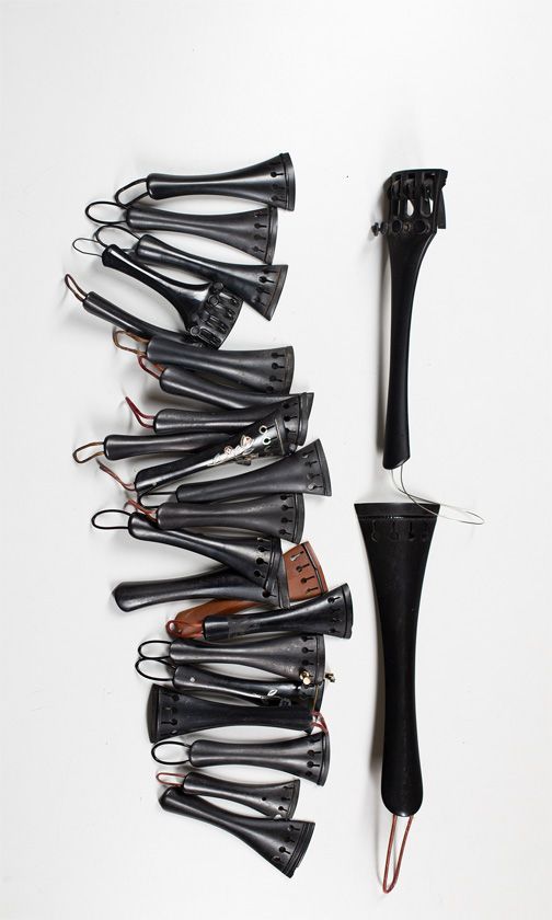 Twenty violin tailpieces and two cello tailpieces