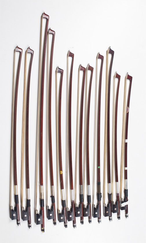 Twelve child's violin bows, various sizes