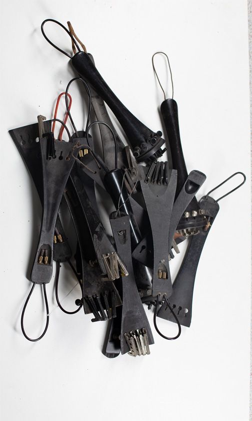 Fifteen cello tailpieces, various sizes