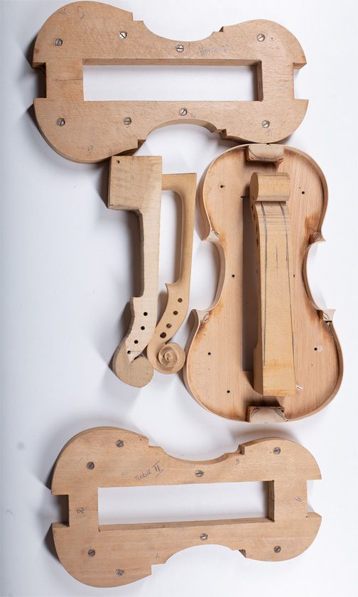 Four violin making moulds and three violin necks
