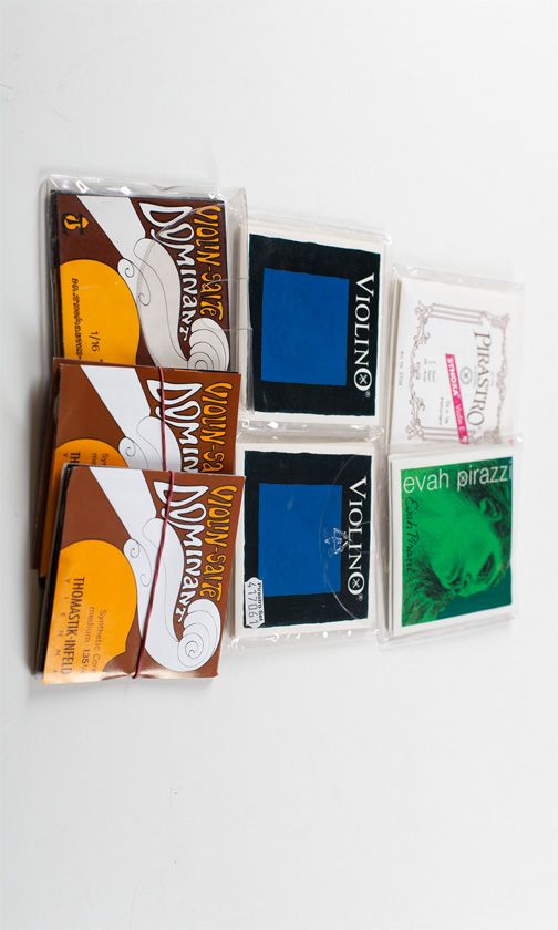 Seven sets of child’s violin strings, various brands