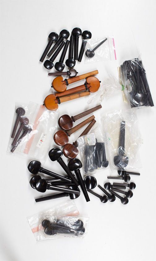 Twenty cello pegs, seven viola pegs and twenty-eight violin pegs