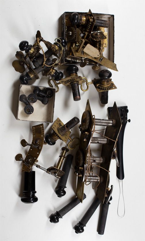 A large quantity of bass and cello machine heads