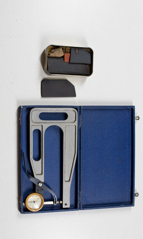 One thickness gauge and a quantity of sharpening stones and spool clamps