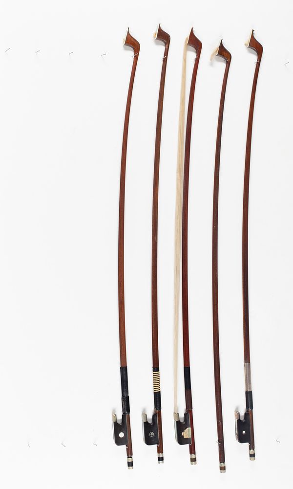 Four cello bows and one cello bow stick