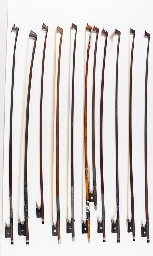 Nine violin bows and two child's violin bows, various sizes