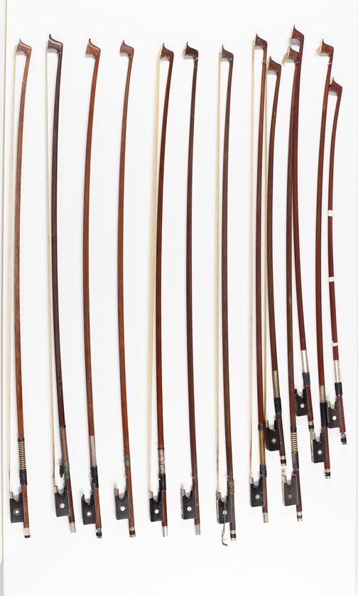 Thirteen violin bows and four child's violin bows, various sizes