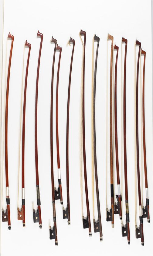 Five violin bows and thirteen child's violin bows, various sizes