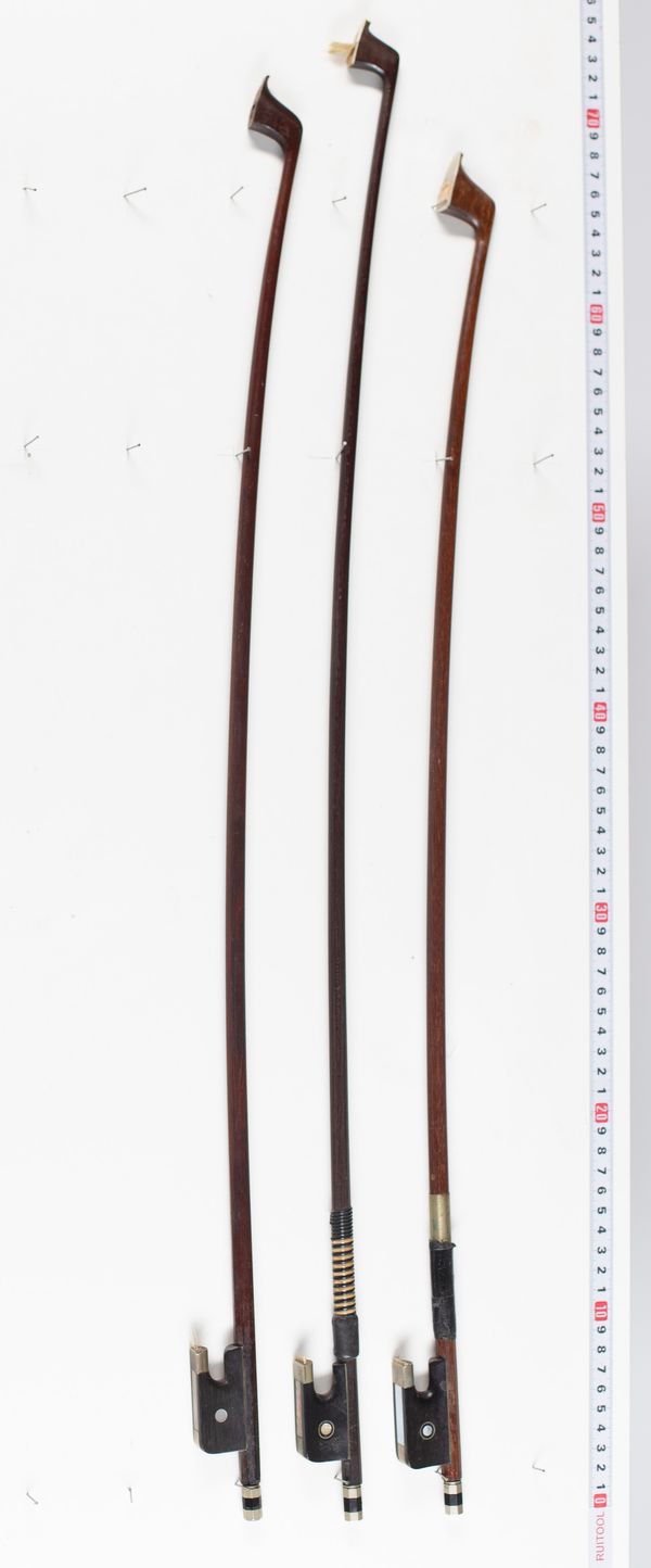 Three cello bows, varying lengths
