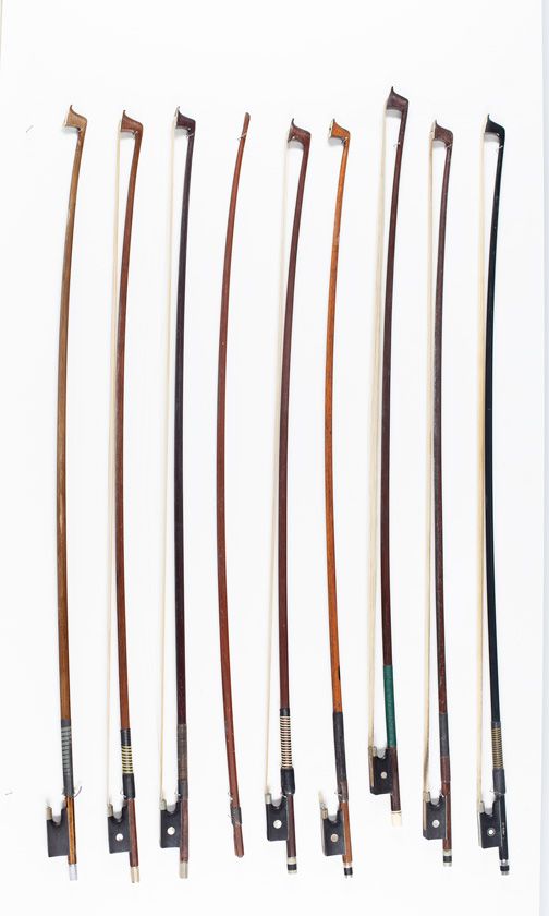 Eight violin bows and one bow stick