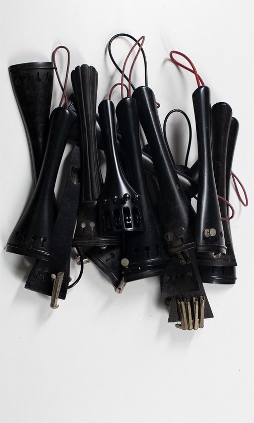 Fifteen cello tailpieces, various sizes