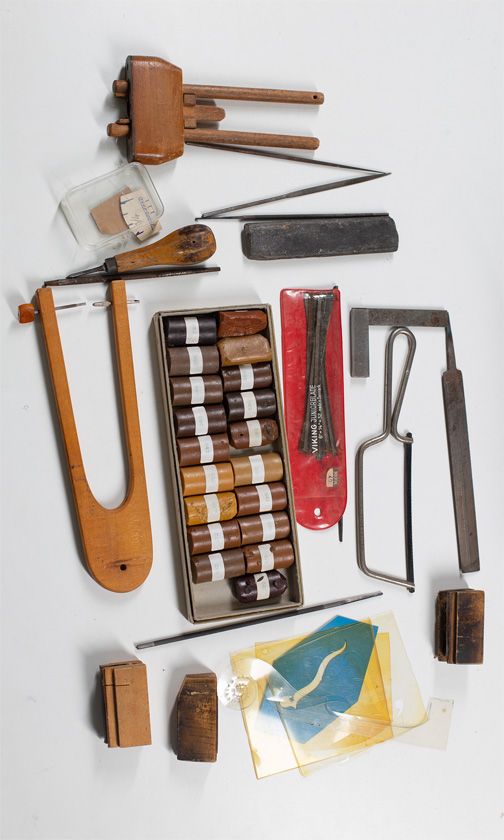 A large quantity of various tools including a purfling cutter, a micrometer, violin f-hole templates and a selection of wax sticks