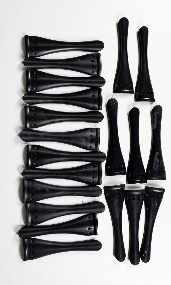 Twenty ebony cello tailpieces