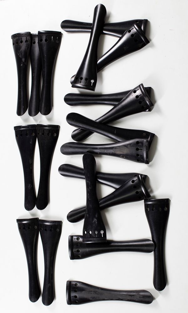 Twenty ebony cello tailpieces