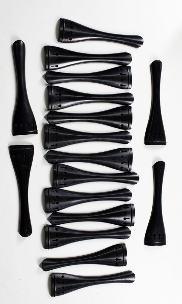 Seventeen ebony cello tailpieces