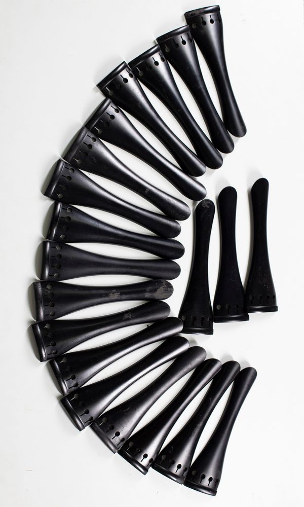 Twenty ebony cello tailpieces