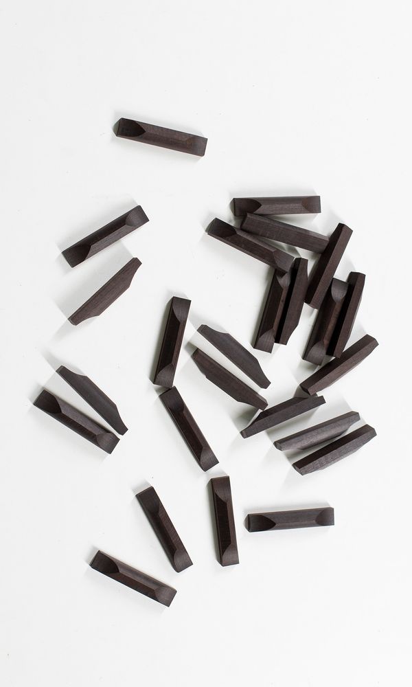 Twenty five ebony cello bottom saddles