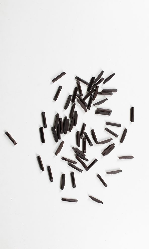 Sixty ebony violin bottom saddles