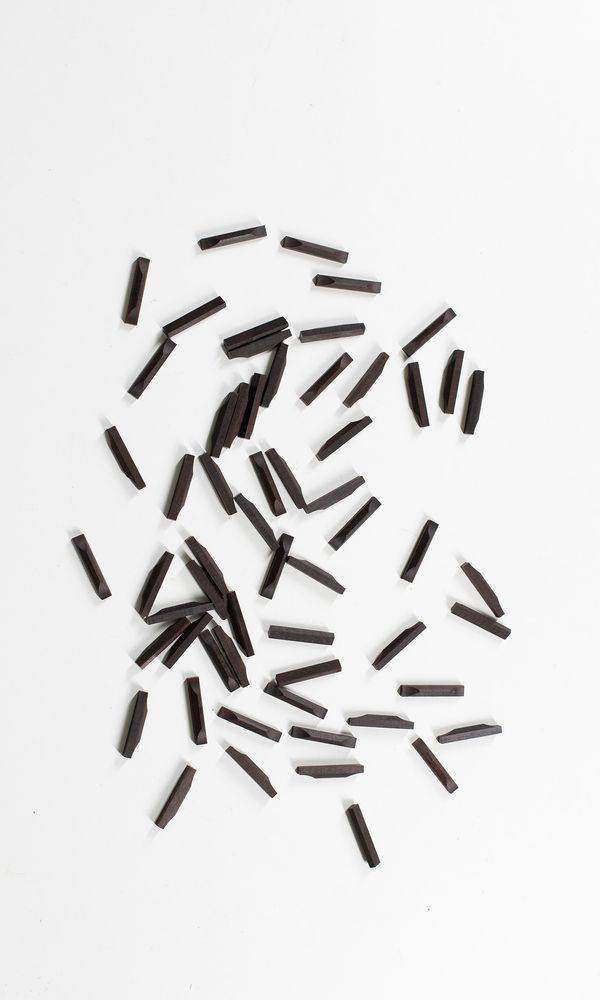 Sixty ebony violin bottom saddles