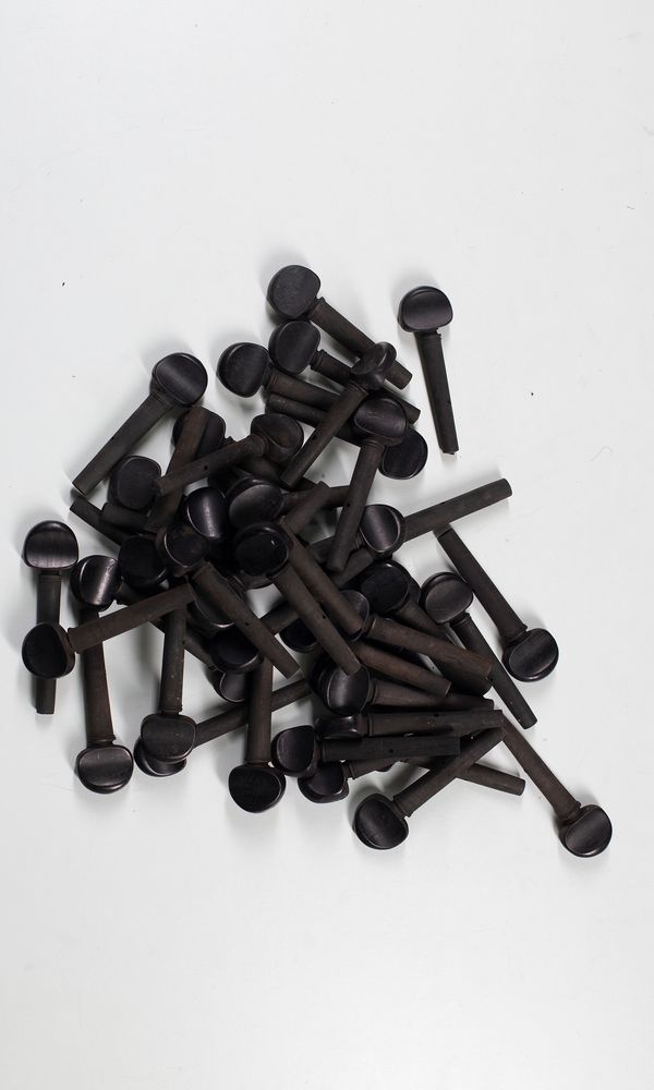 Seventy pearwood child's cello pegs, various sizes