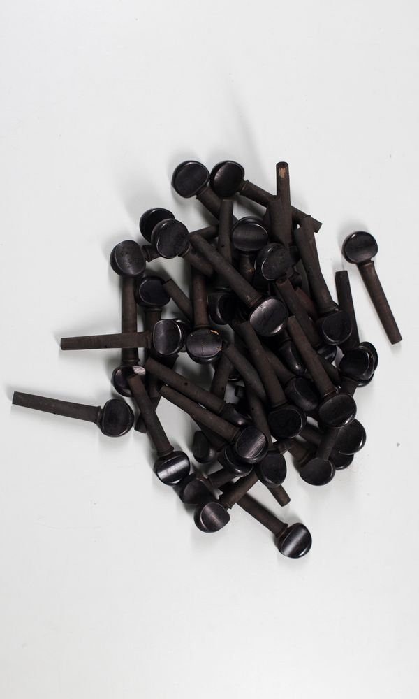 Forty-nine pearwood three-quarter size child's cello pegs